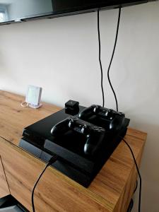 a black device sitting on top of a wooden table at Vila Citadella in Svitavy