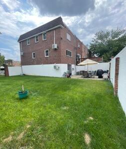 a large yard with a brick building and a building at Nolibs Green Haven Sleeps 12 in Philadelphia