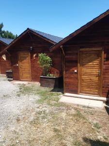 a wooden building with two doors and a plant at Ağva Bungalov Adult Only in Sile