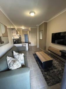 a living room with a couch and a coffee table at Home away from Home in Pretoria