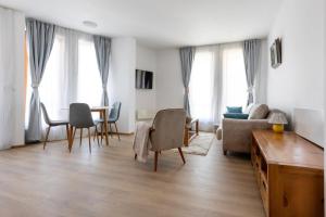 a living room with a table and chairs at Light One Bed Flat next to the Ski Lift in Bansko