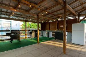 a large open kitchen with green flooring in a building at El Flamingo Beach Club in Manati