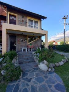 a house with a stone walkway in front of it at Gracias Viejo in Merlo