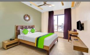 a bedroom with a large bed and a window at Elite Boutique Hotel in Satara +29 photos