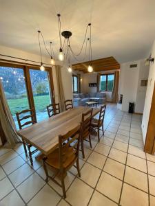 a dining room with a wooden table and chairs at Chalet de montagne in Séez