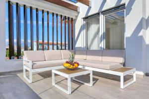 a couch and a table on a balcony at Villa Linda in Zaton