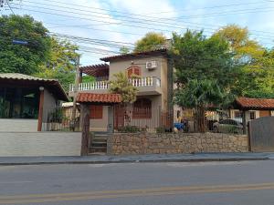 a house on the side of a street at Flat Miguel Pereira in Miguel Pereira
