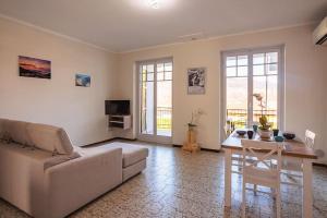 a living room with a couch and a table at Lake Maggiore Holiday Apartment in Feriolo