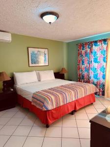a bedroom with a large bed in a room at Simply Mystical in Ocho Rios