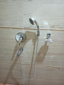 a shower in a bathroom with two faucets at Hotel Ashok Vihar in Bhabua