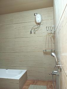 a bathroom with a sink and a bath tub at Hotel Ashok Vihar in Bhabua