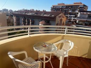 a table and chairs on a balcony with a view at apartamento luxury en Fuengirola in Fuengirola