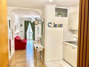 a kitchen and living room with a red couch at SuiteCorso in Vibo Valentia