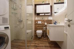 a bathroom with a shower and a toilet and a sink at Yellow Sky Apartment * Spacious with free parking in Novi Sad