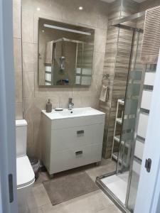 a bathroom with a sink and a toilet and a mirror at apartamento luxury en Fuengirola in Fuengirola +18 photos