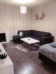 a living room with a couch and a coffee table at Vartiomaja - beautiful apartment near Arktikum in Rovaniemi
