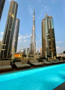 a swimming pool with a view of the city at Chic & Spacious 2BR l Burj & Fountain Views l near Dubai Mall l Pool l Gym in Dubai
