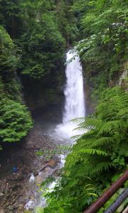 a waterfall in the middle of a river at Zua Bungalow in Pazar