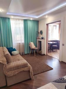 a bedroom with a bed and a living room at Бирюзовый стиль in Chernihiv