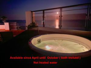 a bath tub sitting on the side of a building at Exclusive luxury frontline beach penthouse Casares del mar - Estepona in Casares