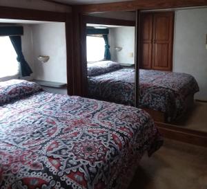 a bedroom with two beds and a mirror at Dark Ridge HideOut in Elk Park