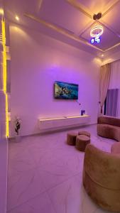 a living room with purple lighting and a couch at Geminge shortlet in Port Harcourt