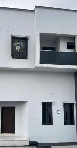 a white building with two windows and a door at Geminge shortlet in Port Harcourt
