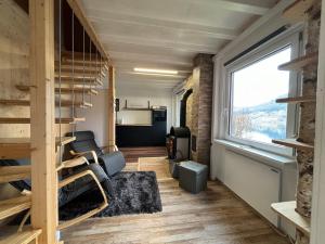 a tiny house with a large window and a living room at Kantor Lodges & Chalets in Millstatt