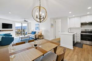 a kitchen and living room with a table and chairs at Brooks Beach Vacations House B222 Oceanside in Oceanside