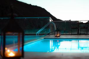 a swimming pool with a light and a lantern next to it at Riad Rihana Dades in Boumalne