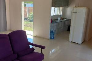a kitchen with a purple chair and a refrigerator at Casa quinta Las Juana in Paraná