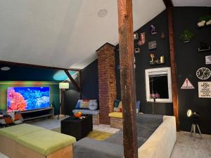 a living room with a large fish tank on the wall at Blue Orange Hostel in Skopje