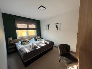 1 dormitorio con 1 cama con silla y ventana en Pokoje i apartamenty Antonówka en Władysławowo