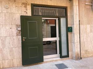 una porta verde sul lato di un edificio di Appartamento Cosy Centro Storico a Barletta