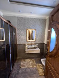 a bathroom with a sink and a toilet and a mirror at Madinty - Luxury villa with Amazing private garden مدينتي - فيلا فندقيه فاخرة in Madinaty