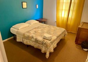 a bedroom with a bed and a blue wall at Artist in the Barn in Philadelphia