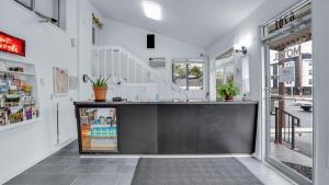 a kitchen with a black counter in a building at Viking Motel in Portland