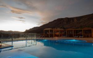 a swimming pool with a mountain in the background at Riad Rihana Dades in Boumalne Dades