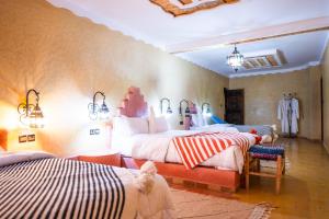a bedroom with two beds in a room at Riad Rihana Dades in Boumalne