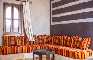 a living room with a couch with an american flag at Riad Rihana Dades in Boumalne