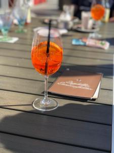 a glass of orange liquid sitting on a table at Ferienwohnung Nebelhorn in Dagebüll in Dagebüll
