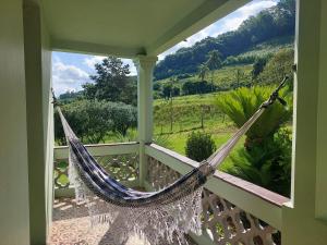 a hammock on a porch with a view at Colônia da Nona Angélica in Farroupilha