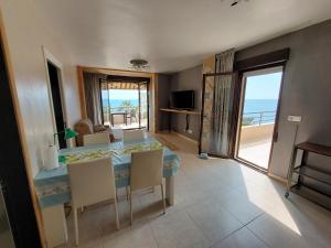 a dining room with a table and a view of the ocean at FantaSea House Salobreña in Salobreña