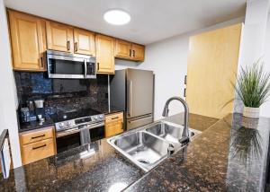 a kitchen with a sink and a microwave at Brooks Beach Vacations Cottage G5 Oceanside in Oceanside