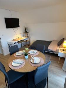 uma sala de estar com uma mesa e cadeiras e um sofá em Ruhige, stadtnahe Wohnung im hamburger Westen em Schenefeld