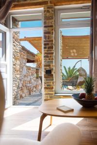 a room with a window and a table at White & black Suites in Platis Yialos Sifnos