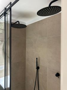a shower with two lights in a bathroom at דירת נופש בהרצליה in Herzliyya B