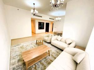 a living room with two couches and a table at Entire apartment in JBR Rimal 3 Dubai in Dubai