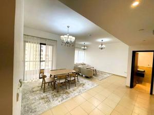 a dining room with a table and a couch at Entire apartment in JBR Rimal 3 Dubai in Dubai