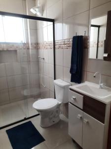 ein Bad mit einem WC, einem Waschbecken und einer Dusche in der Unterkunft Selva Park - Apartamentos completos - próximo ao Beto Carrero e praias in Penha